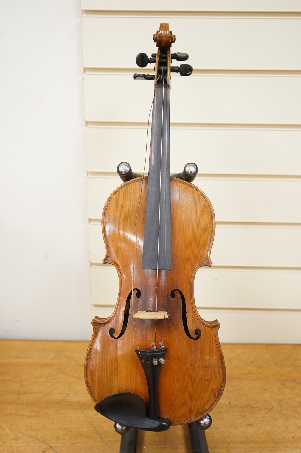 Four violins; a German Dresden violin, together with further two German violins, and a Saxony violin, three in cases or the remains of cases.